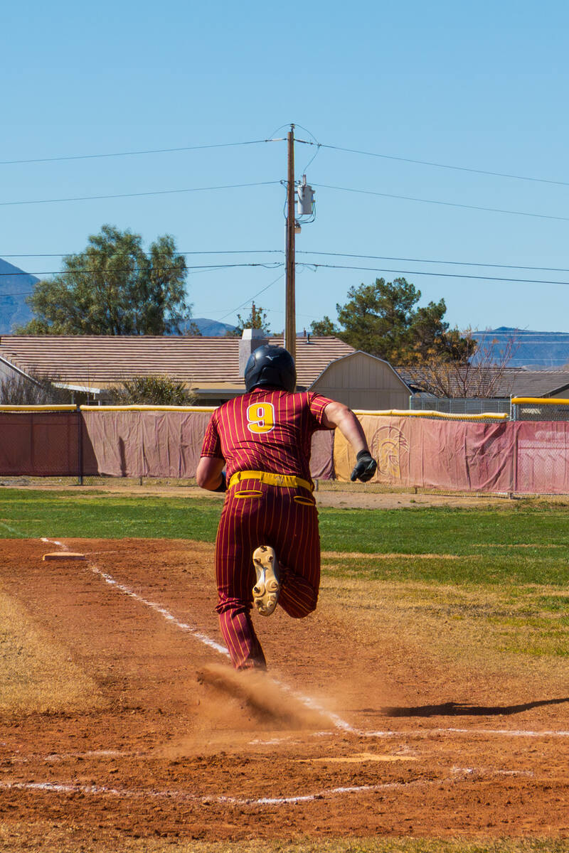 Pahrump Valley High School junior Cody Fried sprints down the first base line during the champi ...