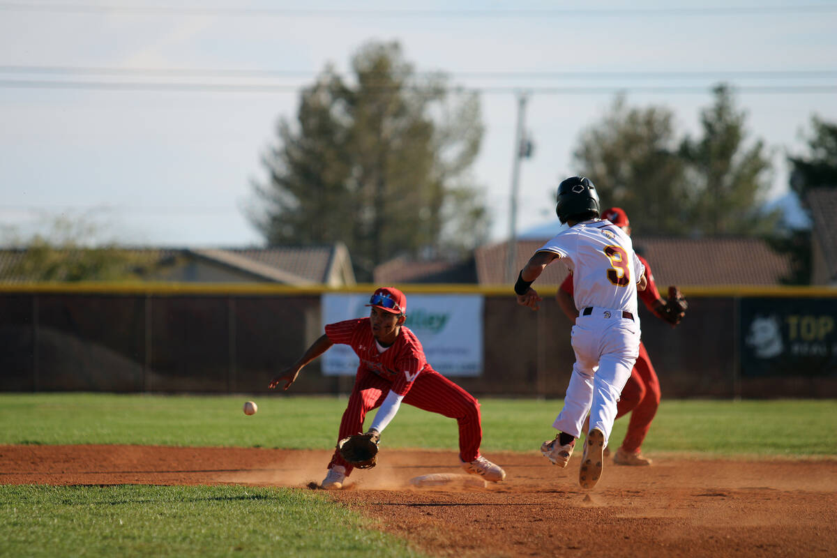Pahrump Valley High School senior Vinny Whitney tries his best to evade a tag at second base du ...
