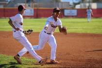 Pahrump Valley High School's Samuel Mendoza and CJ Nelson both go after the ball to first base ...