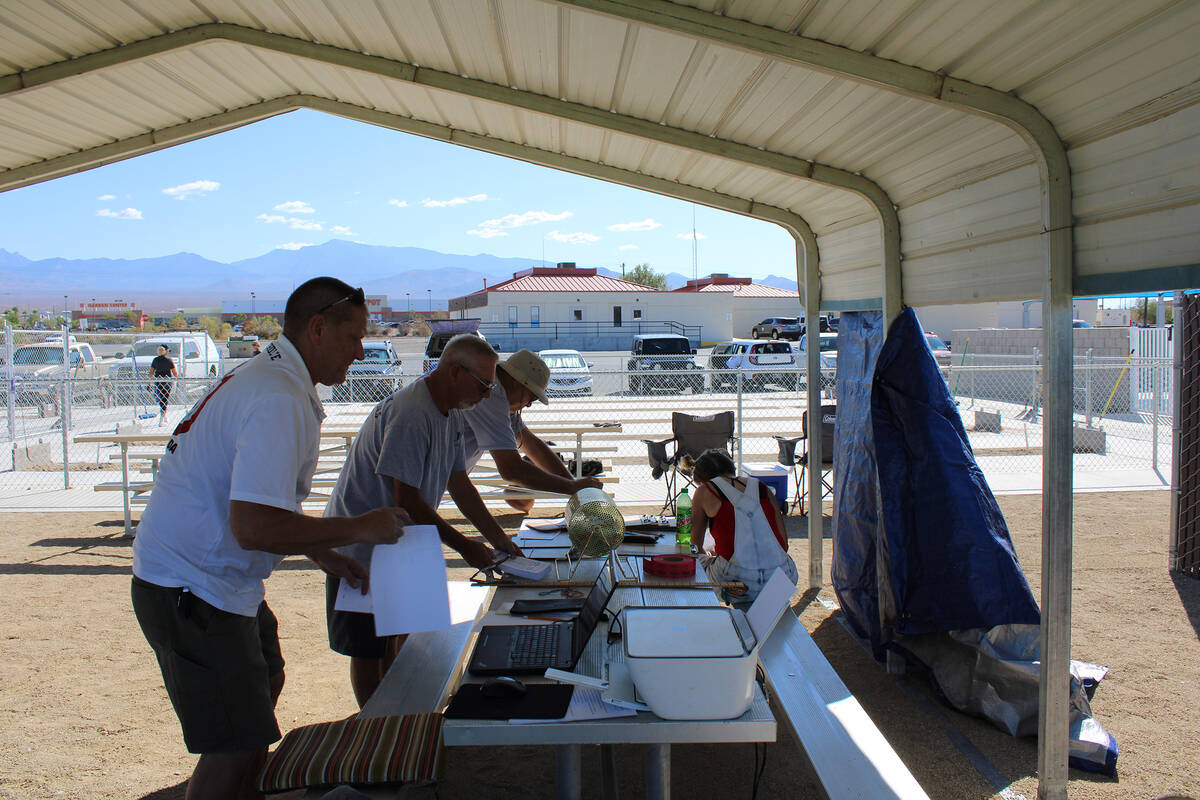 Nevada State Horseshoe Pitchers Association pitchers gather to tally their scores during an eve ...