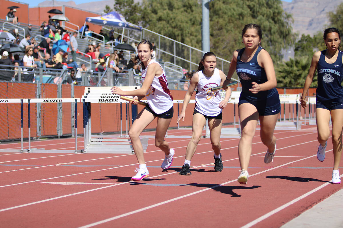 Pahrump Valley High School sophomore Ava Bowers passes off her relay baton to teammate and soph ...