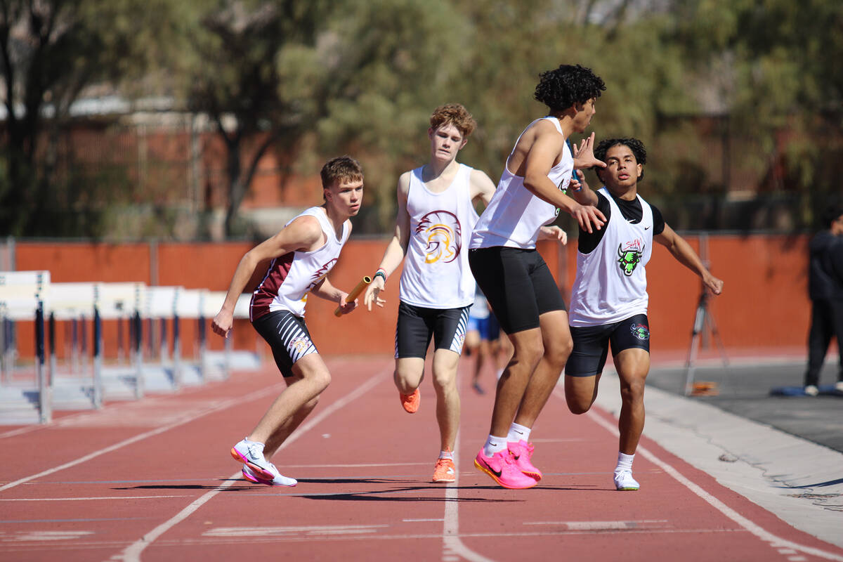 Logan Tilley (left) and Daniel Thompson (right) pass off their relay baton during the 4x800 rel ...