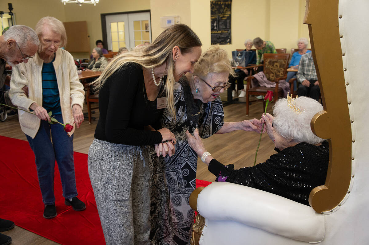 During Jean Luppo’s birthday celebration, attendees lined up to hand her roses and wish her a ...