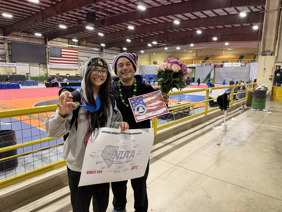 Mika Yoffee and father Johnny Yoffee proudly show off Mika's last winning state bracket as a se ...