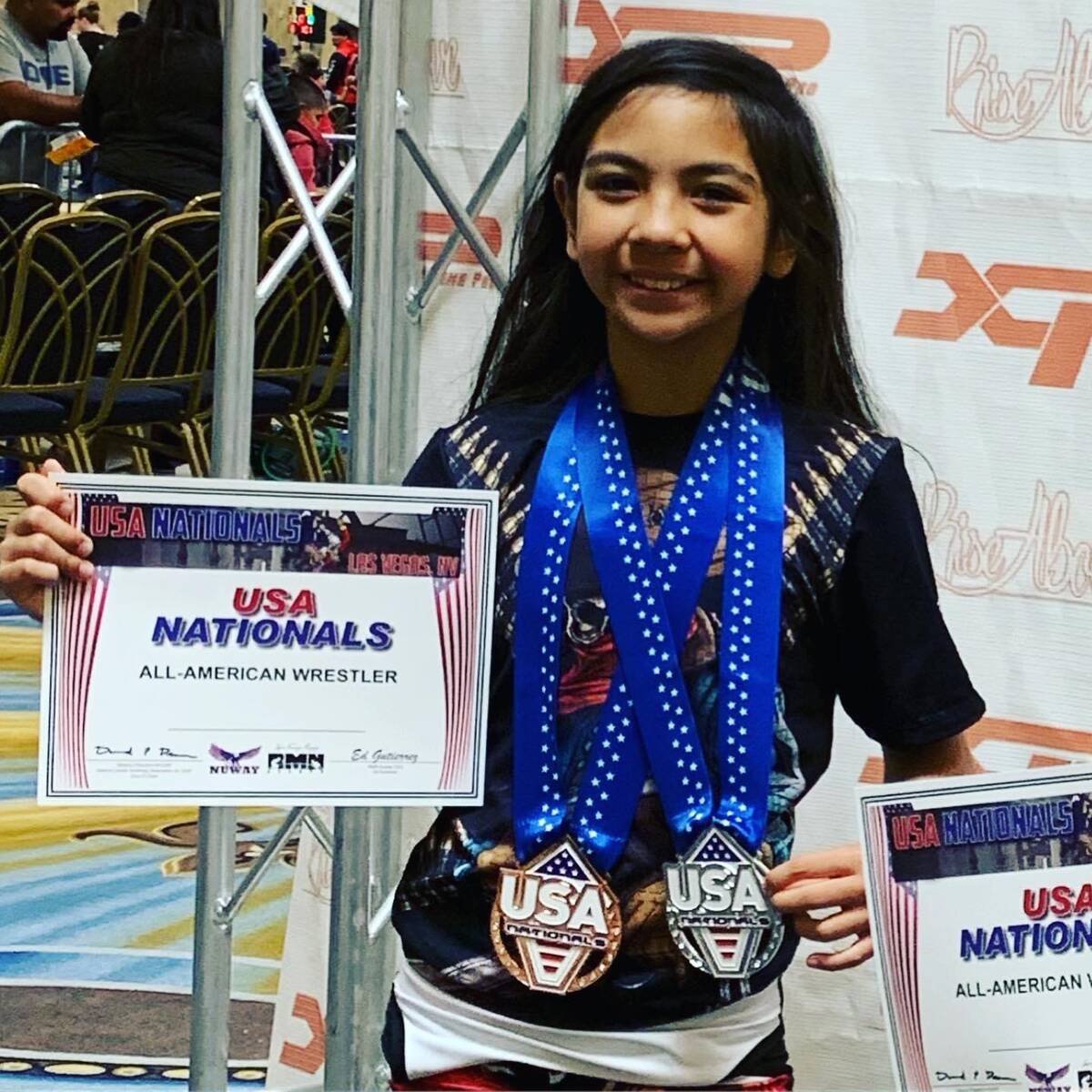 Mika Yoffee proudly displays her USA Nationals certificate after winning multiple medals. (Mari ...