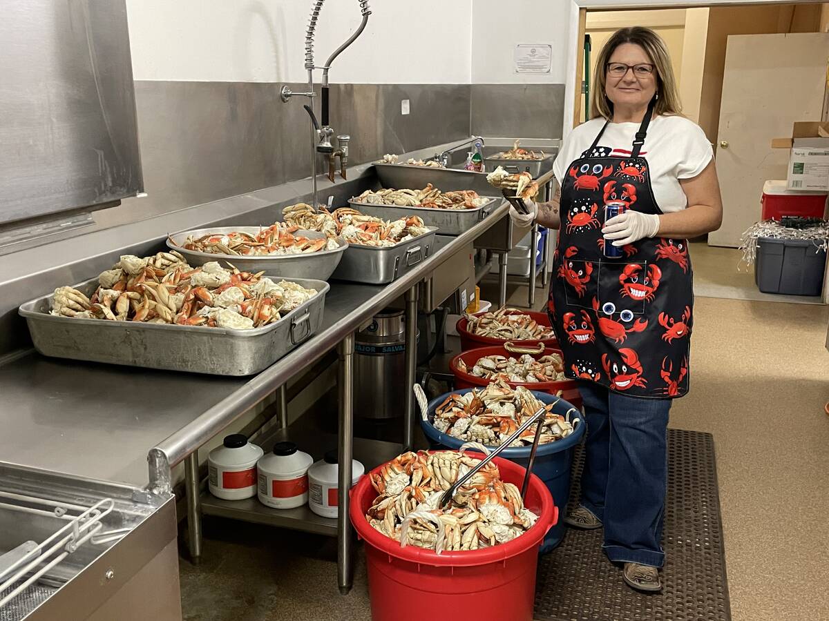 Elks member Chrissy Pope prepares to help serve the 200 Crab Crack ticket holders from this tid ...
