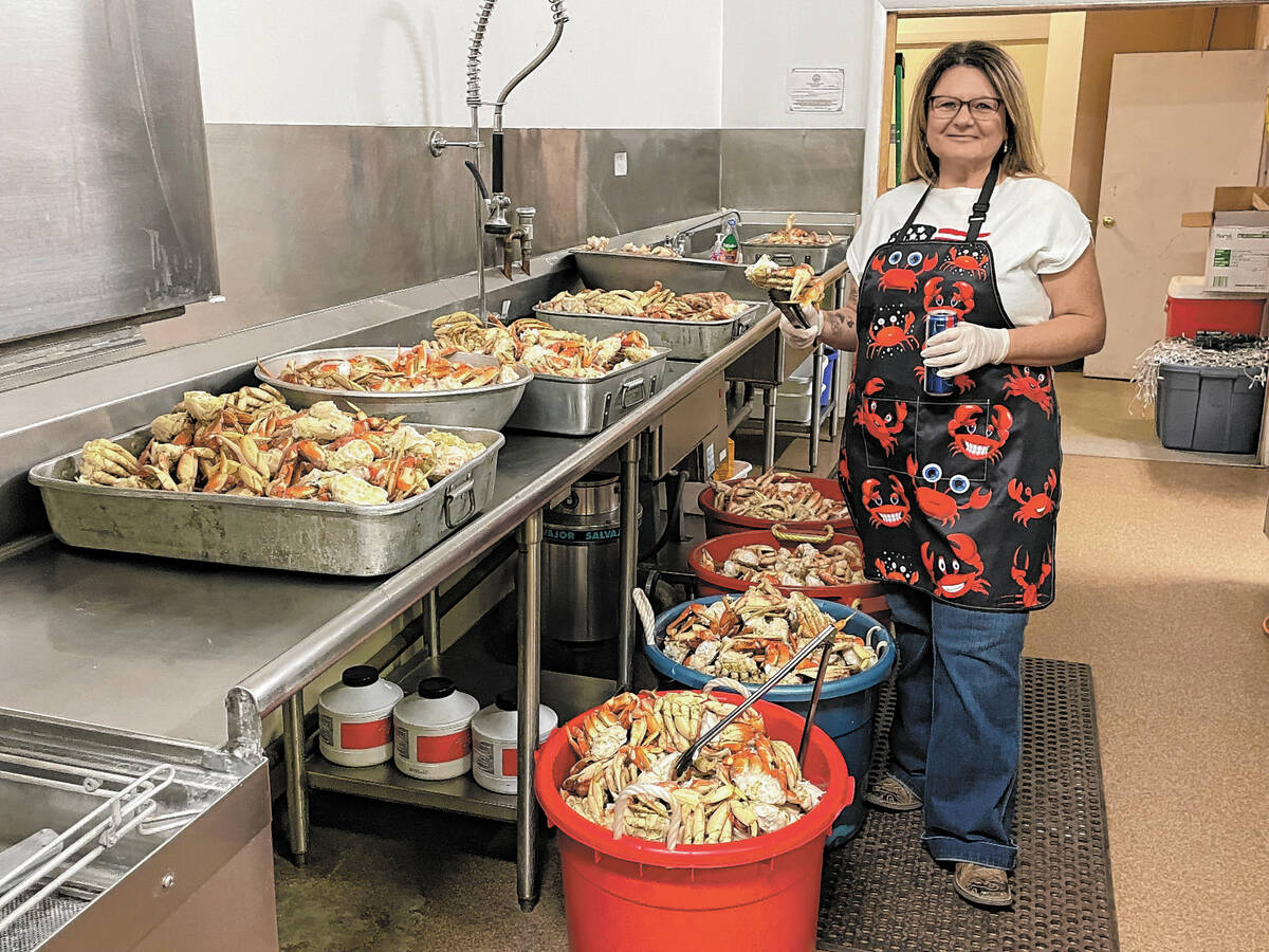 Elks member Chrissy Pope prepares to help serve the 200 Crab Crack ticket holders from this tid ...