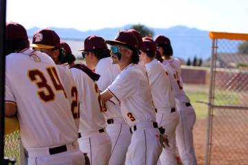 Members of the Pahrump Valley High School baseball team hangout on in the dugout prior to the s ...