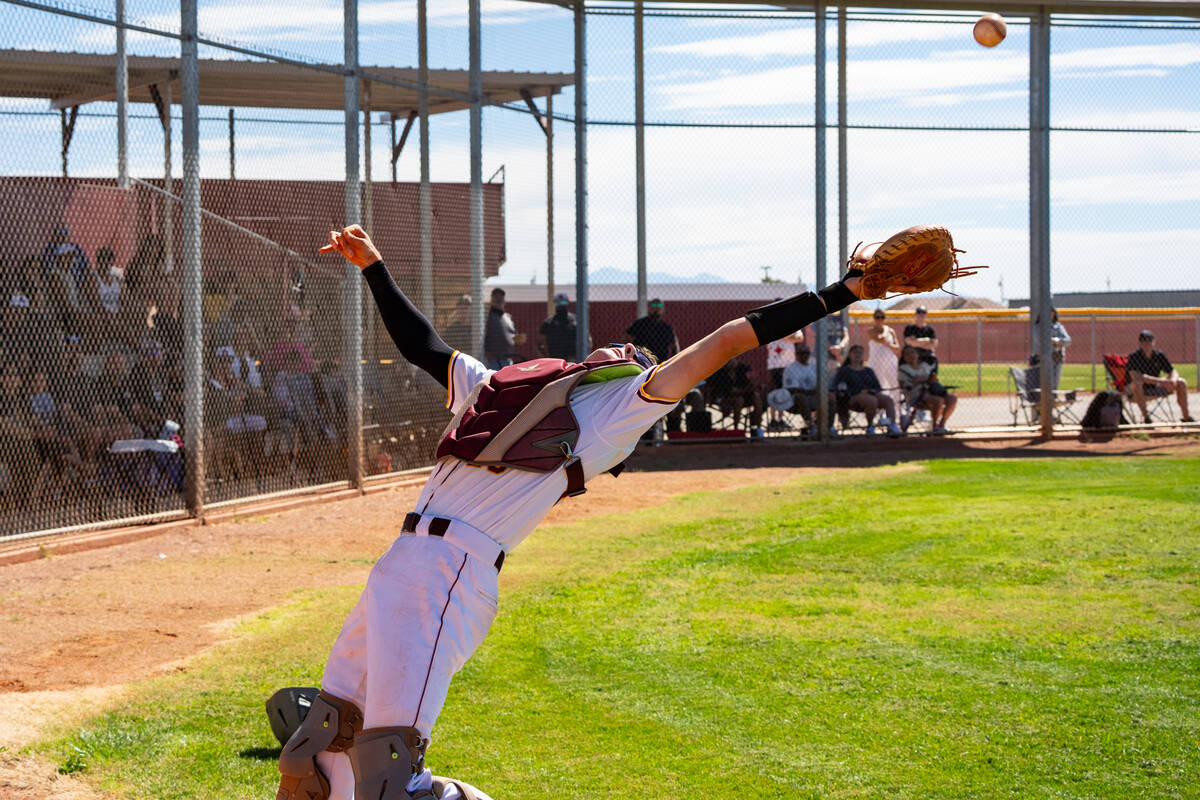 Pahrump Valley High School Ben Cimperman does his best to track down a pop up near the dugout d ...