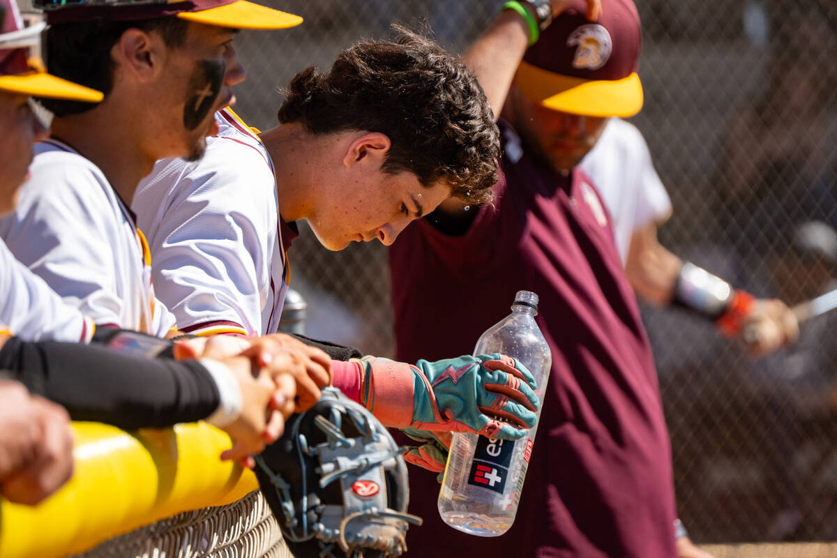 Pahrump Valley High School sophomore Anthony Montanez attempts to cool down during a hot Saturd ...