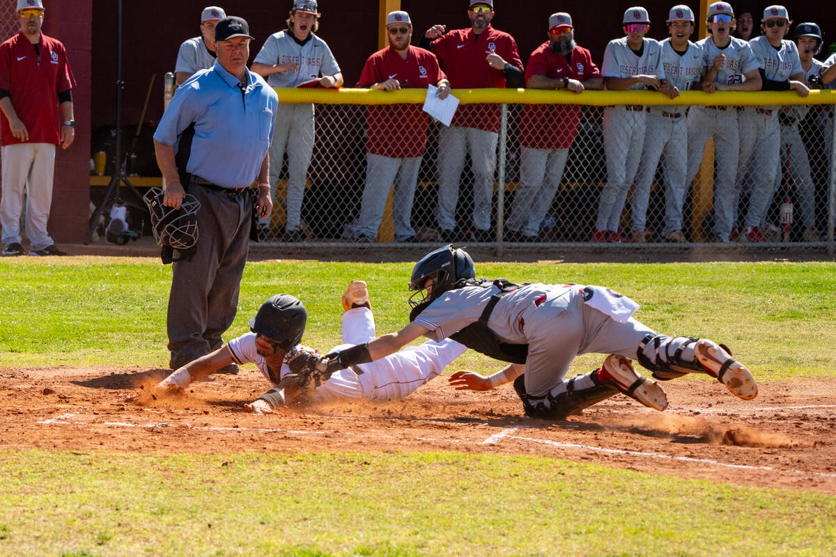 Pahrump Valley High School junior shortstop Tony Whitney extends safely across home plate to sc ...