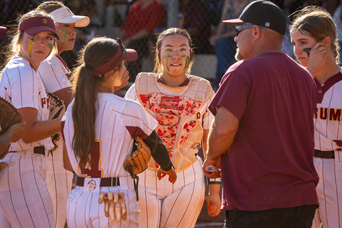 The Trojans call for a mound visit during their non-league home game against Needles High Schoo ...