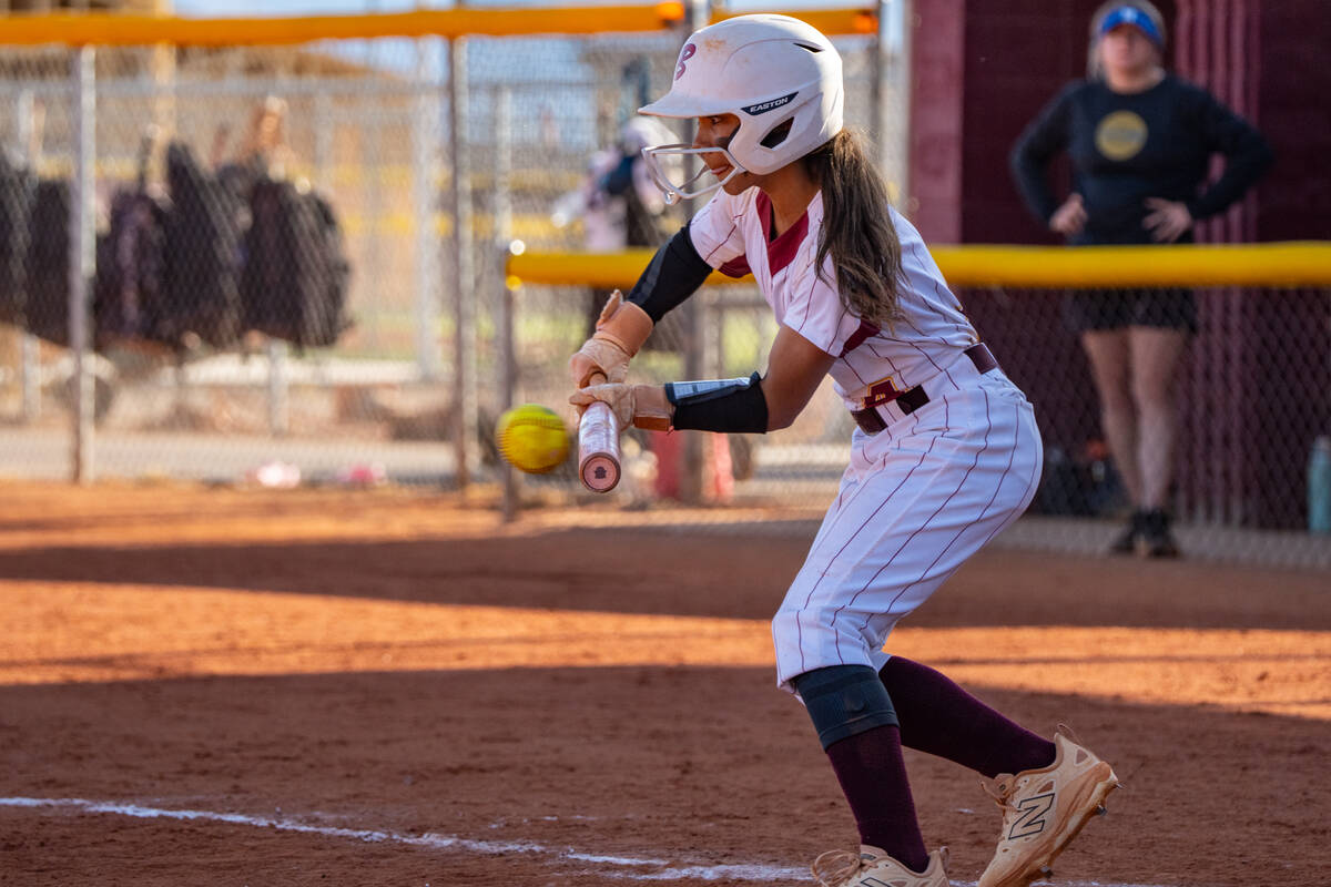 Pahrump Valley High School freshman shortstop Aspen Middaugh attempts to lay down a bunt agains ...