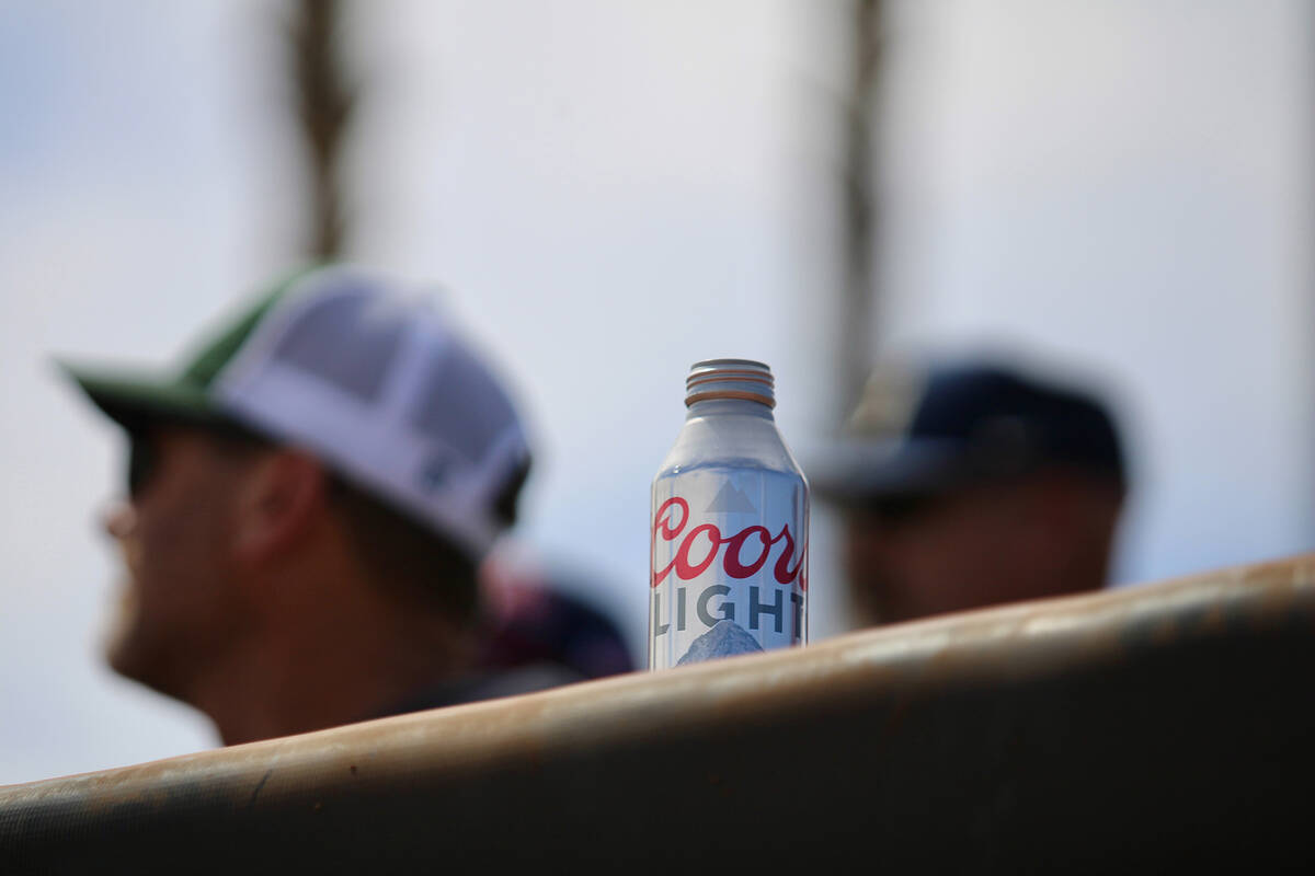 A Utah Tech fan enjoys an ice-cold Coors Light during a scorching hot day at Earl E. Wilson Fie ...