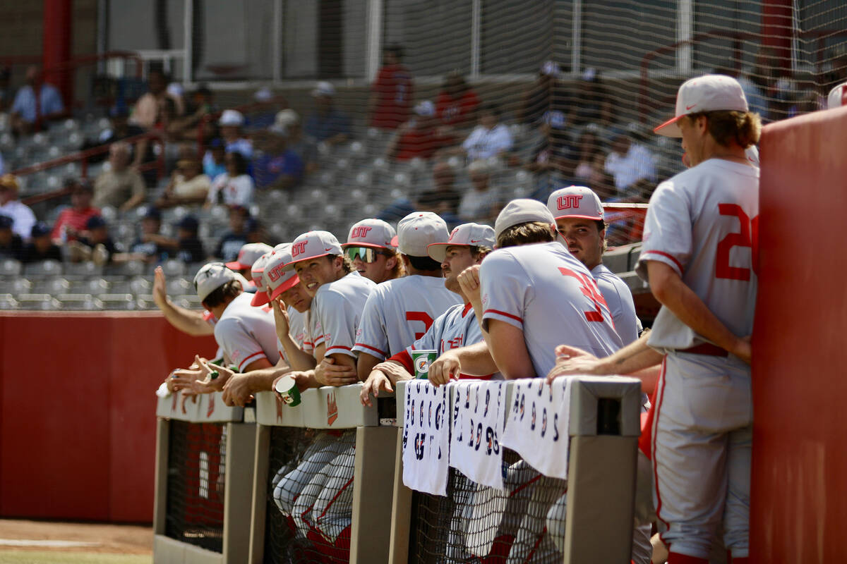 The Utah Tech Trailblazers hang on the visiting dugout fence prior to the start of their game a ...