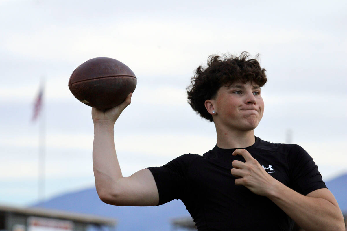 Pahrump Valley High School junior Ryan Hamlin prepares to complete a pass to a receiver during ...