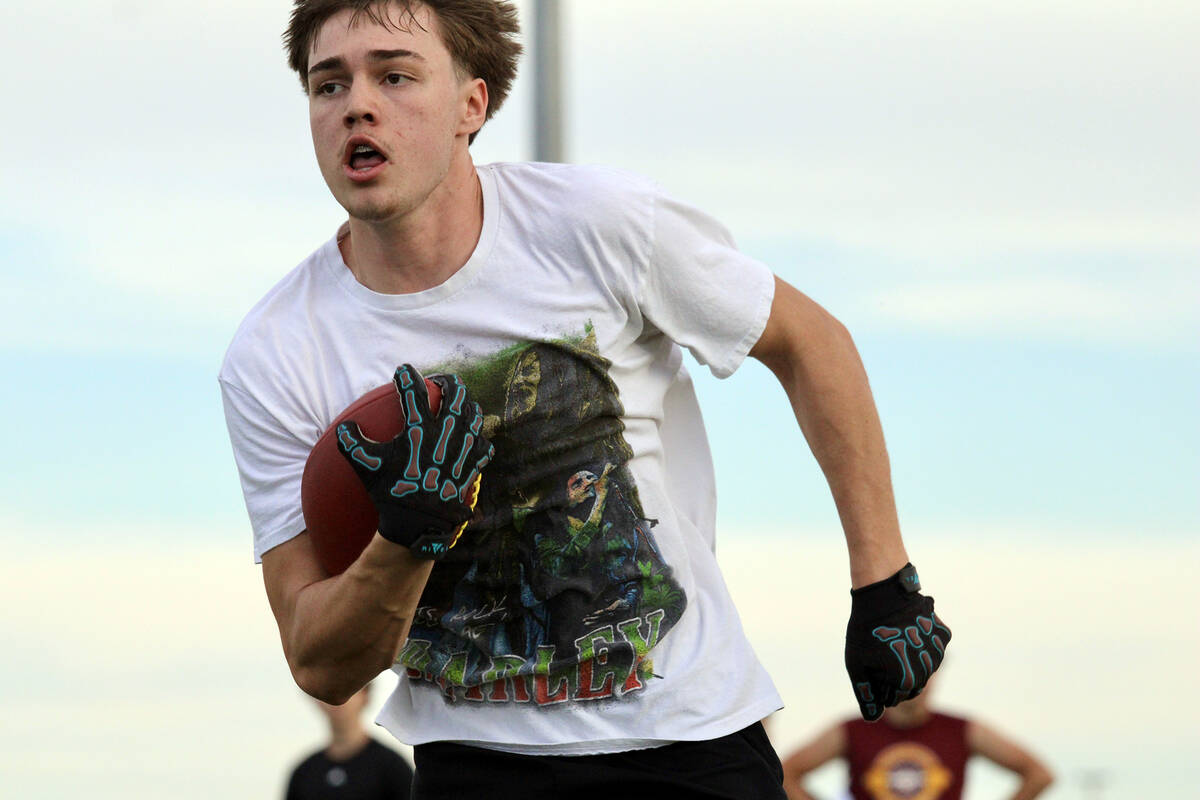 Pahrump Valley High School junior Tristan Torres sprints up the line after reeling in a pass du ...