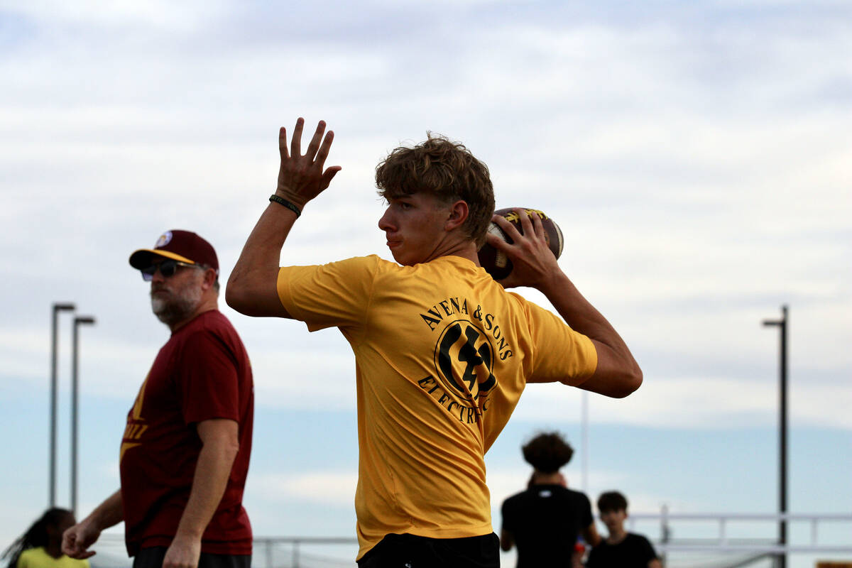 Pahrump Valley High School junior quarterback Hunter Wydick prepares to launch a pass as head c ...