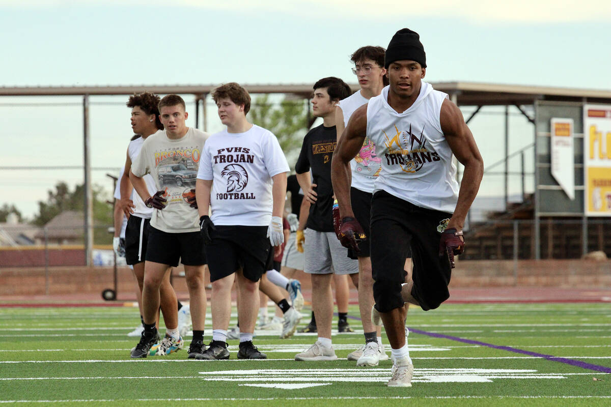 Pahrump Valley High School junior Iyan Bosket sprints off the line to run a route during the Tr ...