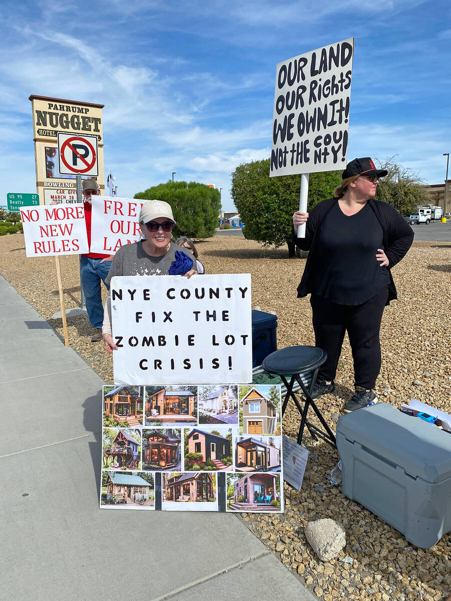 Patricia Robb, center, displays a couple of signs during the Zombie Lot Protest. As lead advoca ...