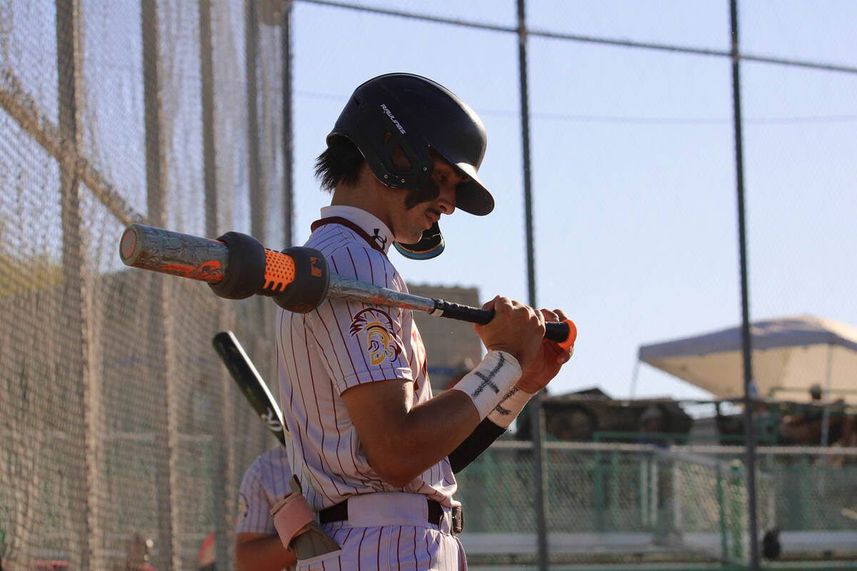 Pahrump Valley High School senior Kayne Horibe adjusts his bat's tape prior to his at-bat again ...