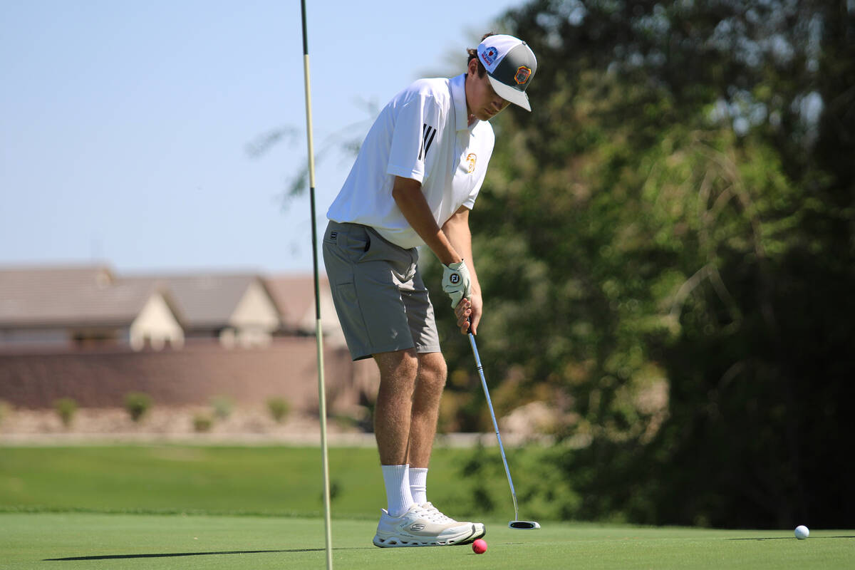 Pahrump Valley High School senior Caden Briscoe attempts to sink his putt during the Trojans' h ...