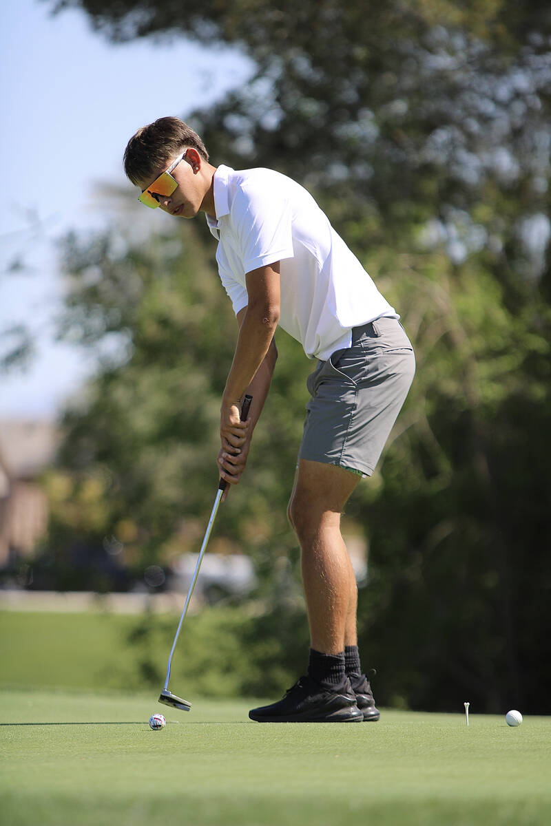 Pahrump Valley High School senior Cayden Cowley looks to close out a round with a smooth putt d ...