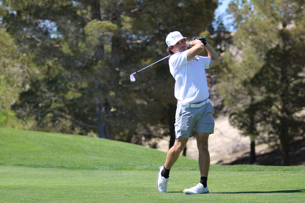 Pahrump Valley High School senior Aaron Rily follows through on his swing during the Trojans' h ...