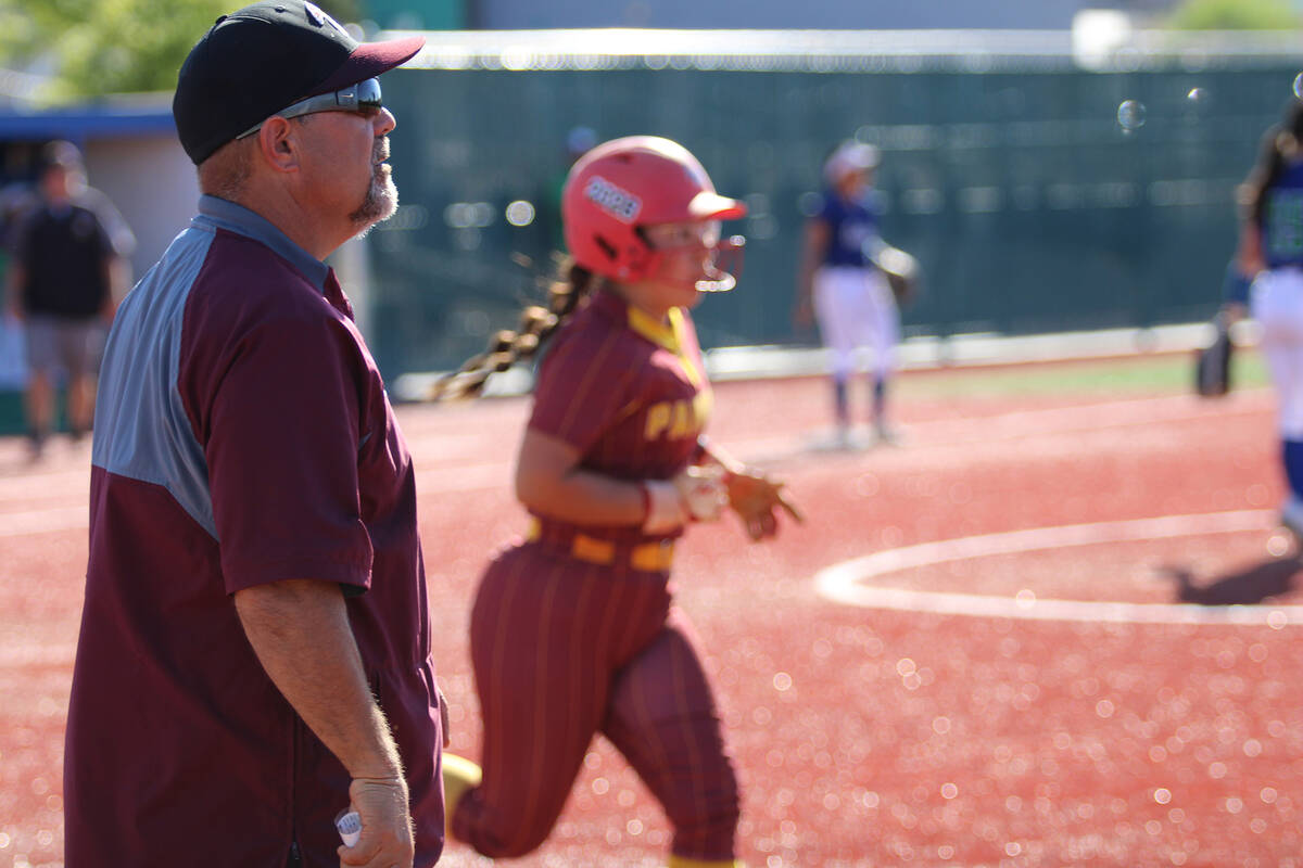 Assistant coach Rich Lauver looks on as senior Madison Rodriguez jogs out to first base after r ...