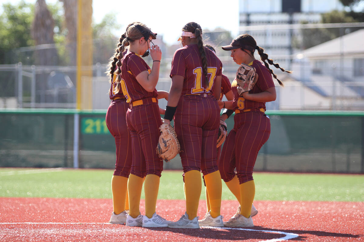 Members of the infield gather during a brief team mound visit during their non-league away game ...