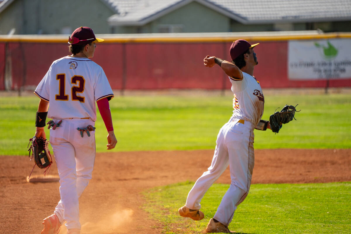Pahrump Valley High School junior Tony Whitney sets his feet to throw a runner out a first base ...