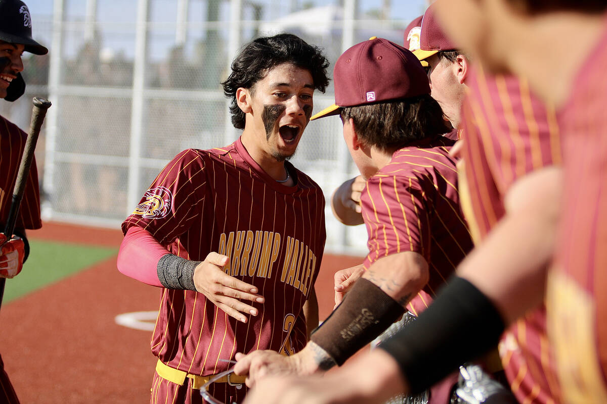 Pahrump Valley High School junior Tony Whitney celebrates down the line with his teammates agai ...