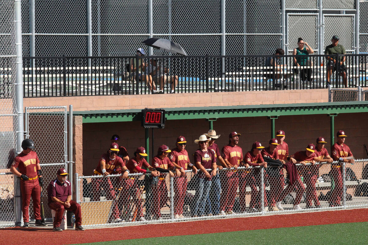 The Trojans hangout in the scorching hot Virgin Valley visiting dugout prior to their second le ...