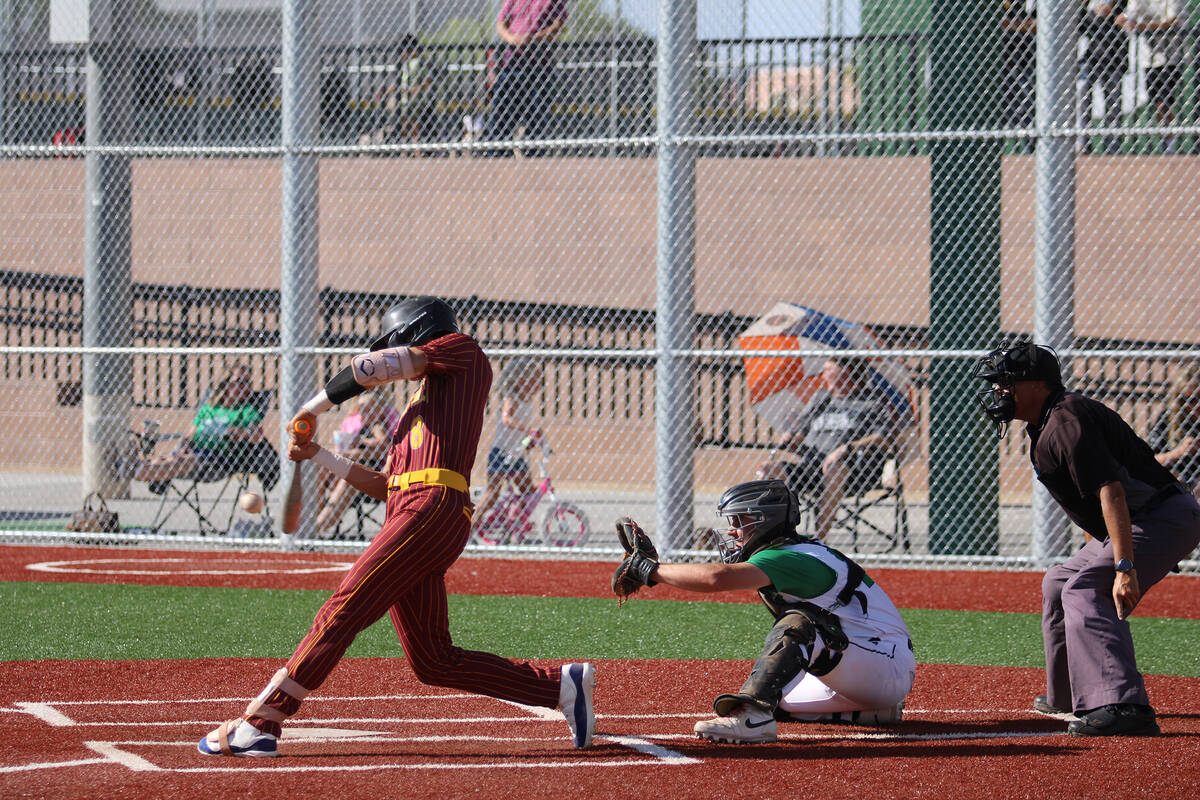 Pahrump Valley High School senior Kayne Horibe connects with the ball for a bases clearing thre ...