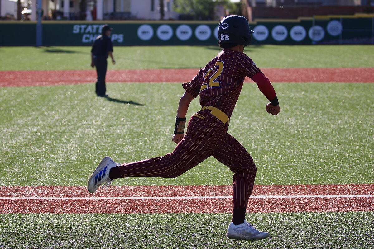Pahrump Valley High School junior Tony Whitney rounds third base and heads home on an RBI doubl ...
