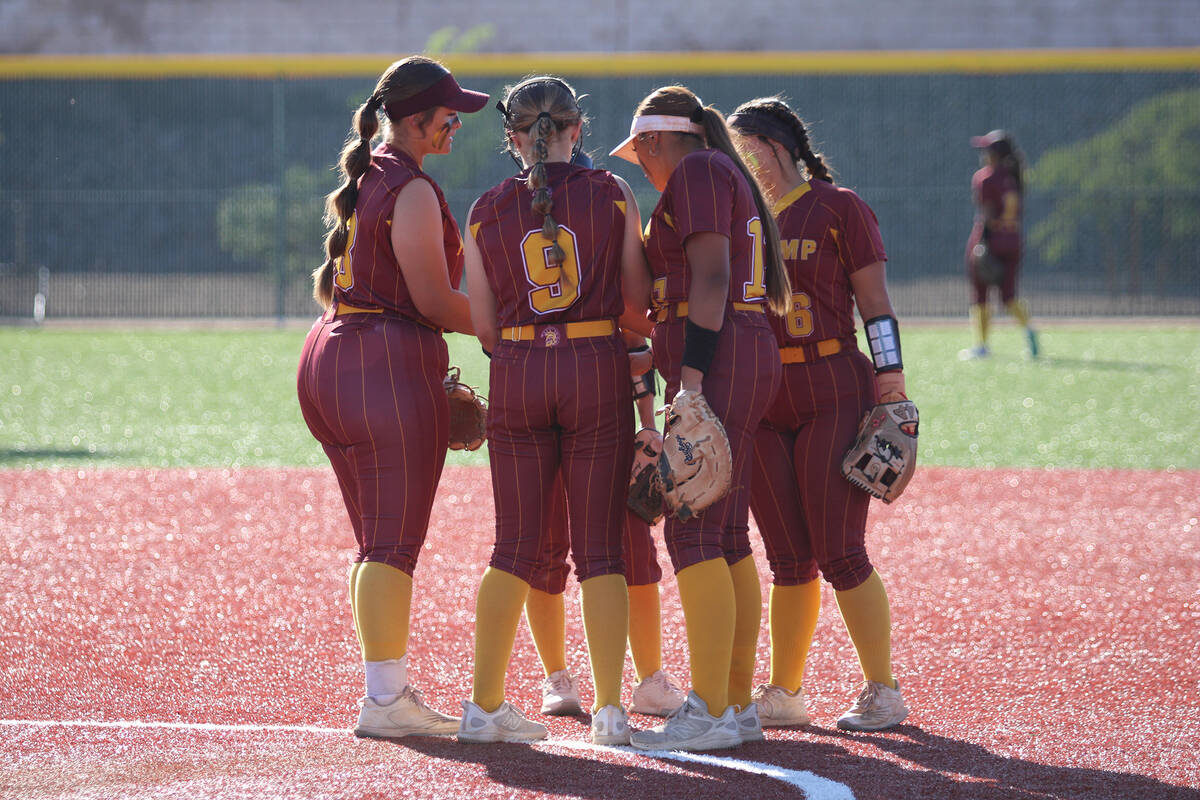 The Lady Trojans gather just outside of the circle before taking the field against Virgin Valle ...