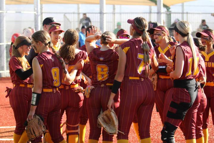 The Lady Trojans gather for a quick team rally before heading into the dugout following the bot ...