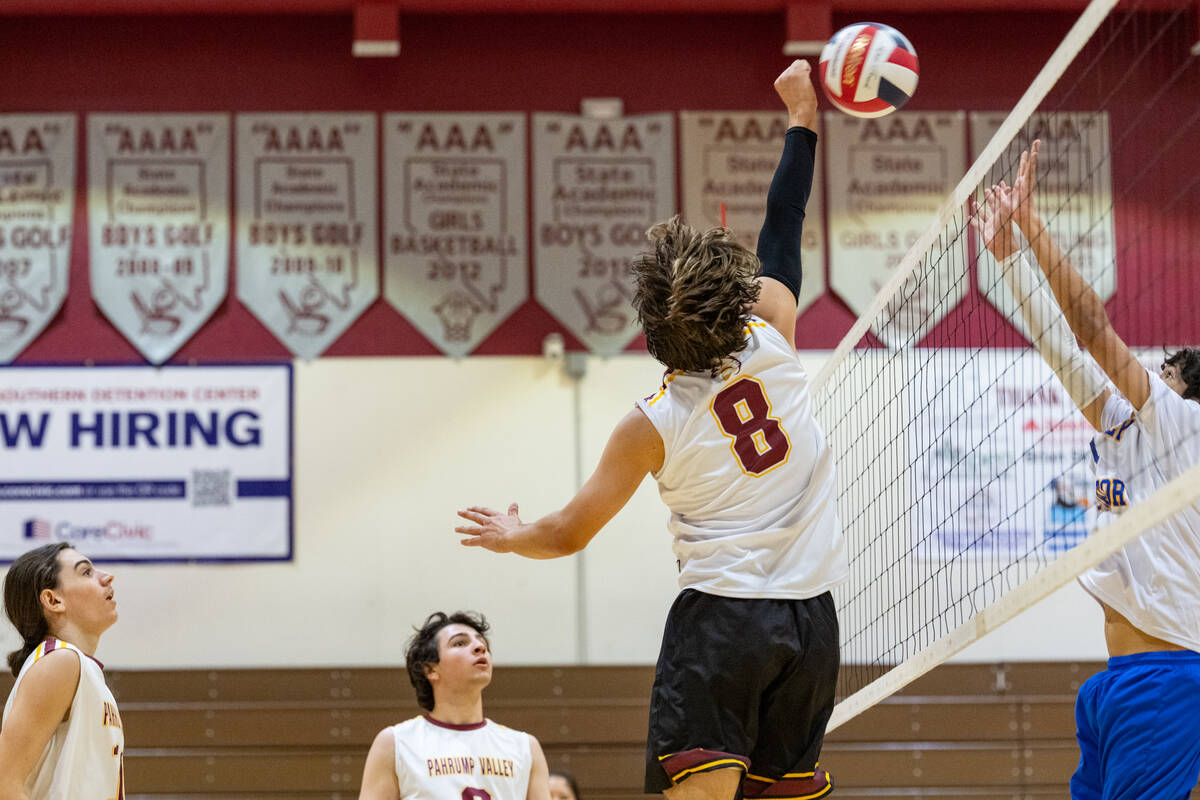 Pahrump Valley High School senior Elijah Thompson tips the ball back over the net during the Tr ...