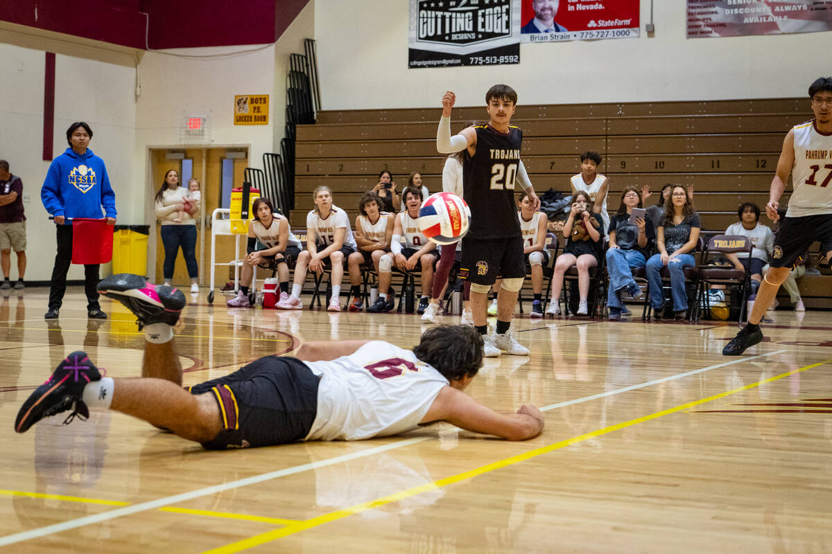 Pahrump Valley High School senior Nicholas Watson extends out during a dig attempt while the Tr ...