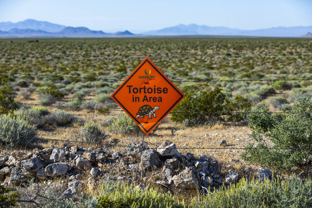 A sign by Greenlink marks a tortoise area beyond a gated entry to the Rock Valley Wash as propo ...