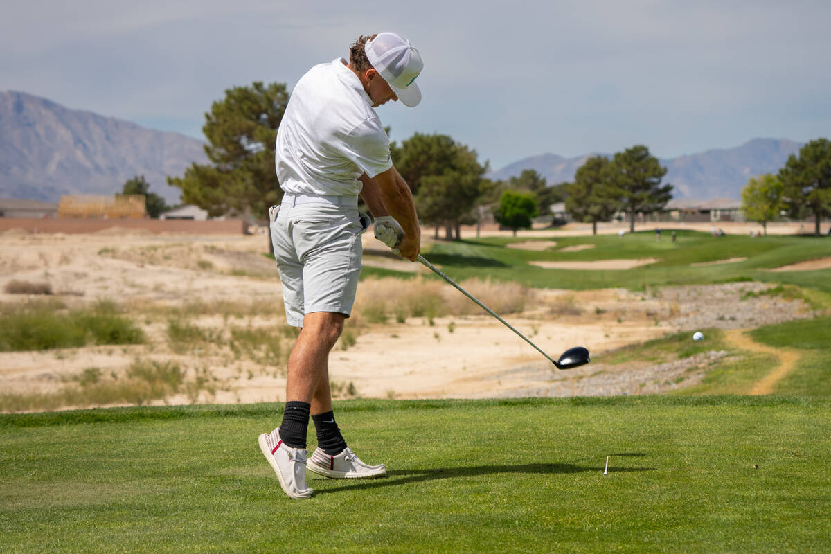 Pahrump Valley High School boys golf junior Travis Floyd drives the ball deep during the Trojan ...