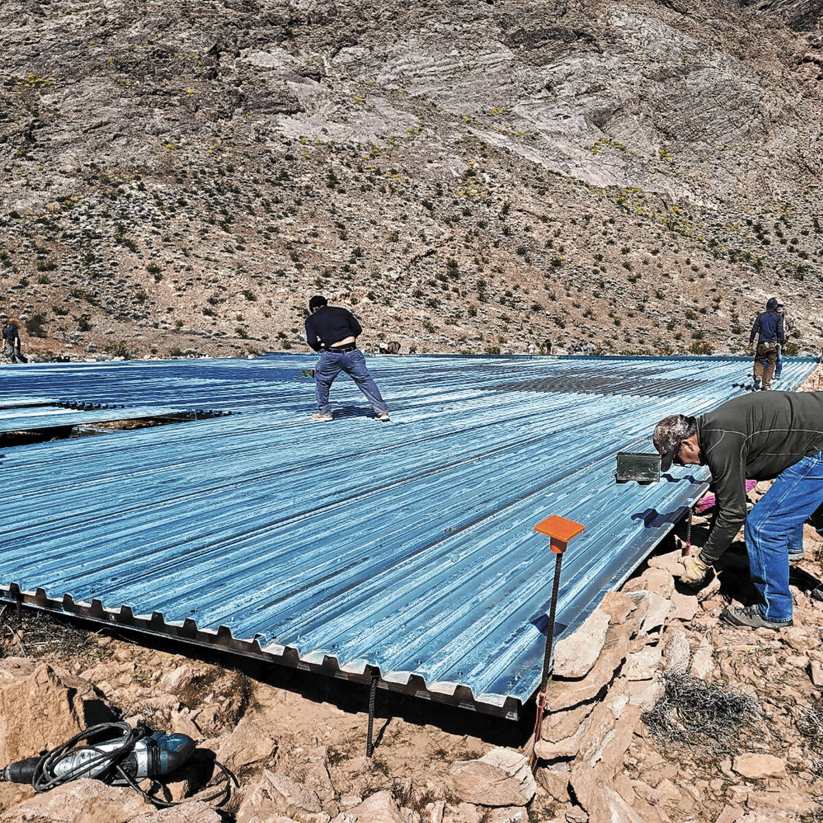 A large apron to catch water for a "guzzler," part of a drinking water project' is in the midst ...