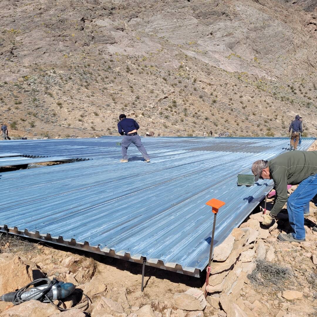 A large apron to catch water for a "guzzler," part of a drinking water project' is in the midst ...