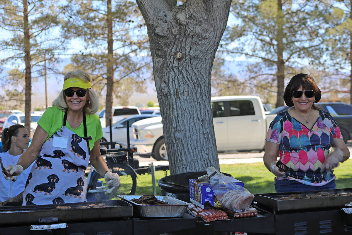 The grills at the Community Easter Picnic saw constant actions as volunteers cooked up hamburge ...