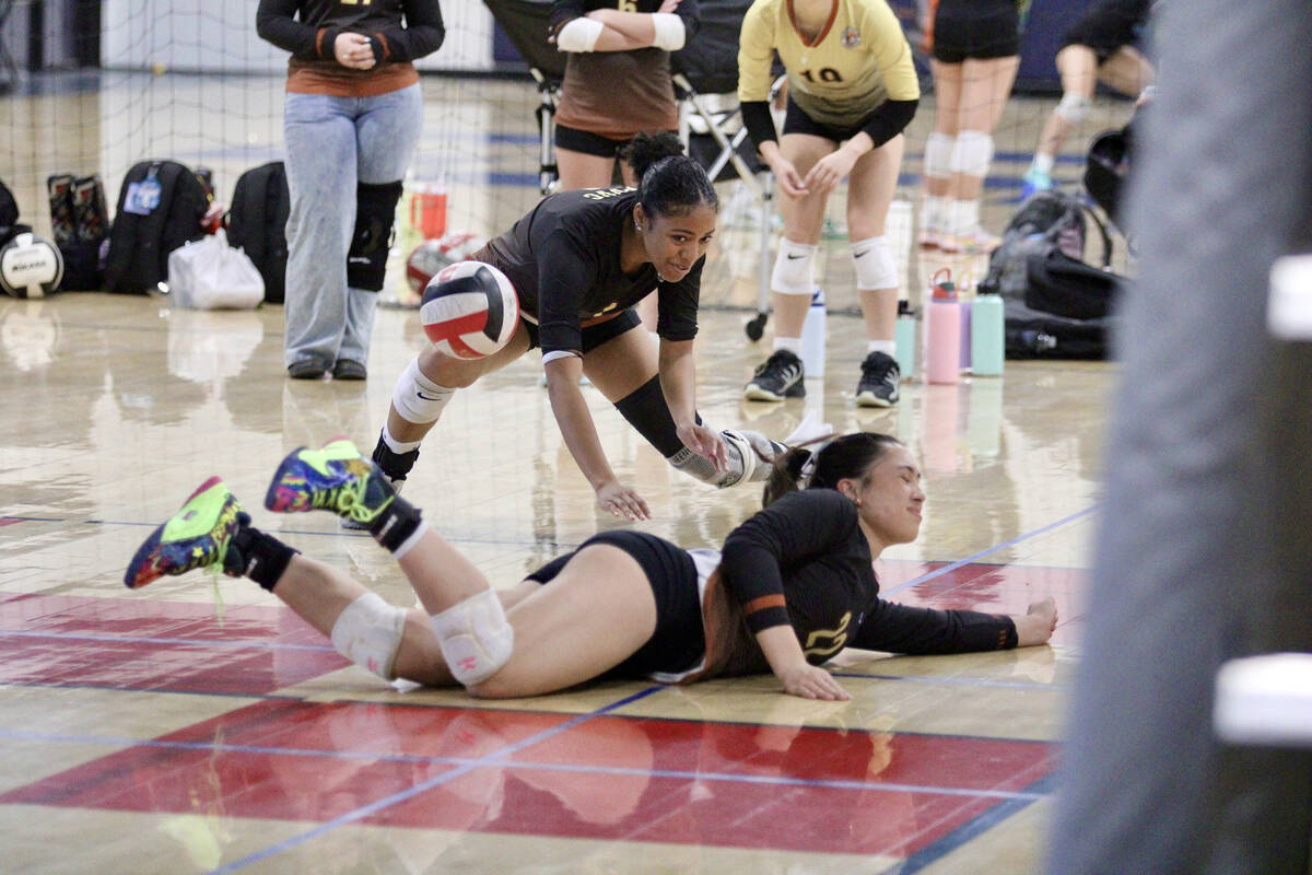 Pahrump Valley Volleyball Club teammates Heavenly Ware and Xe'ane Kamanu try to dig a ball sail ...