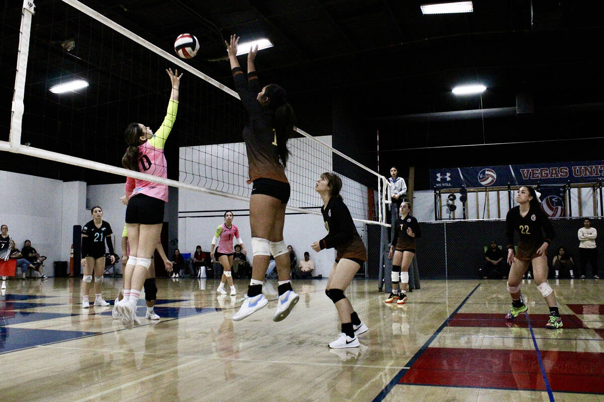 Pahrump Valley Volleyball Club's Miani Freitas-Faamai springs into position to make a block aga ...