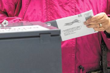 Nye County residents drop off mail-in ballots on Election Day at Bob Ruud Community Center in P ...