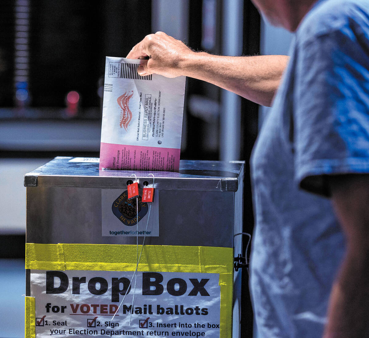 A voter drops off his mail ballot during Nevada's primary election day at the polls within ...