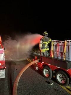 Pahrump Valley Fire and Rescue firefighters battle a lithium-ion battery fire on U.S. Highway 9 ...