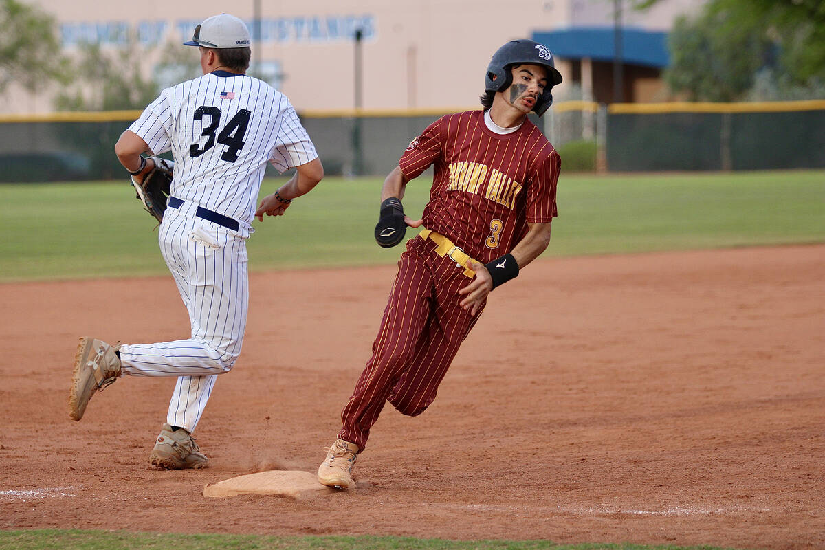 Pahrump Valley High School senior Vinny Whitney rounds third base hard as he attempts to score ...